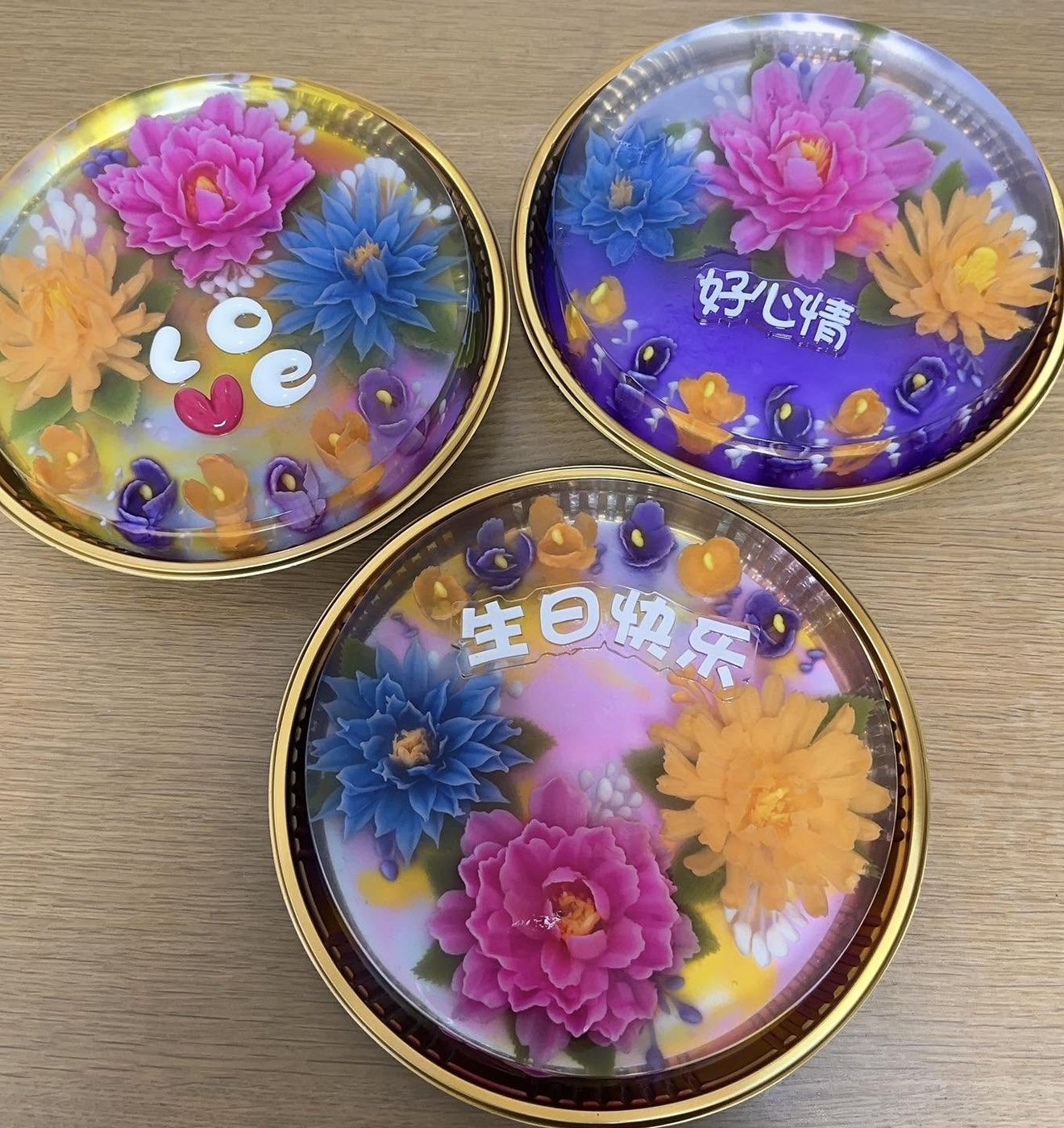 Three round tin jelly cakes with Love and Happy Birthday lettering